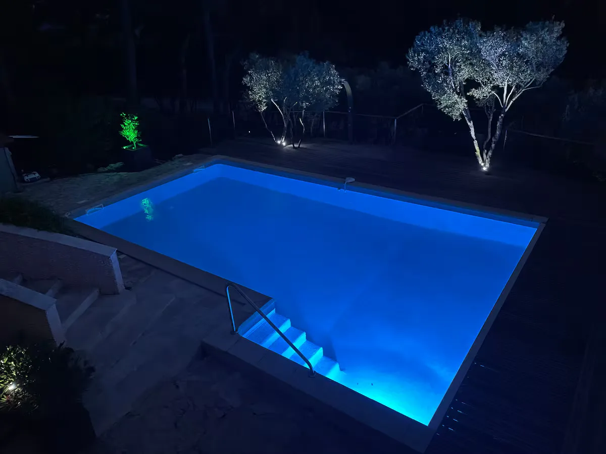 Private pool of the villa lit up at night