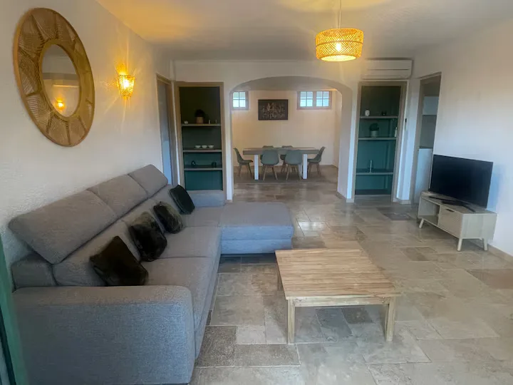 Large living room with sofa, coffee table and television
