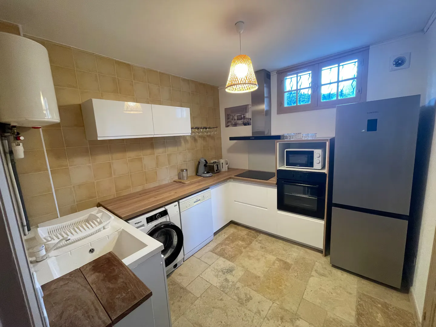 Spacious fully equipped kitchen with refrigerator, washing machine and oven